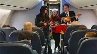 United Airlines Flight Attendant Sings Carols With Passengers During Delay