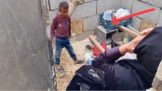 Collecting wood for fire by a nomadic woman and her child