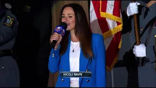 Hockey fans join Nicole Raviv in singing the National Anthem during Stanley Cup Playoffs