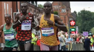 VICTOR KIPLANGAT UGANDA MARATHON GOLD WINNER - ON STREET SCREEN FOOTAGE OF MARATHON
