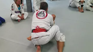 Pedro Sauer showing knee shield pass at his affiliate school Urbana Academy