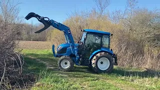 LS tractor moving some brush