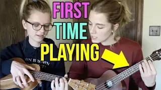 teaching my sister how to play ukulele