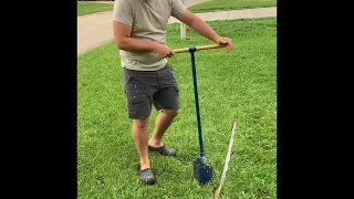 using a seymour hand auger to dig a fence post