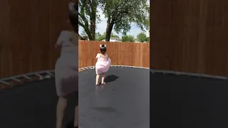 Baby jumping on trampoline.