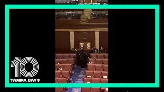 Video from inside the House chamber shows armed guards blocking the door amid protests