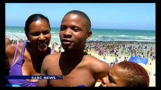 Thousands of people flock to celebrate New Year's Day on Muizenberg beach