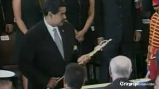 Mahmoud Ahmadinejad kisses Hugo Chavez's coffin