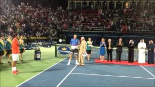 Tomas Berdych collecting trophy after Federer loss at the 2014 Dubai Duty Free Tennis Championships