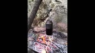 Stainless steel water bottle over the fire