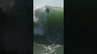 BIG WAVE THROWS SURFER TOWARDS THE BEACH