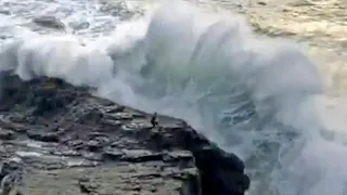 Caught on Camera: Man Swept Off Rocks by Monster Wave