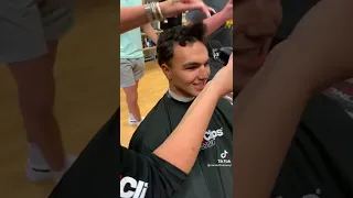 two friends cutting their hair short