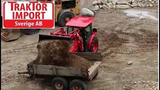 Branson tractor move sand whit front loader