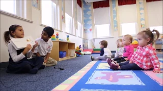 Apple Montessori Kindergartners Read to the Infant Class