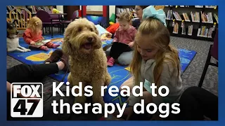 Therapy dogs bring smiles to kids at Holt Public Library