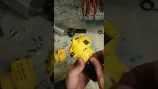 Dewalt DCW600 cordless router with a broken casing and lick button.