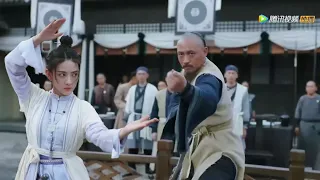 The girl challenges numerous martial arts masters to save the kung fu kid.