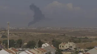 Tall column of smoke rises into the sky over Gaza Strip