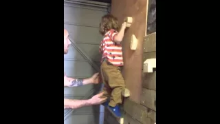2 year old on diy climbing wall