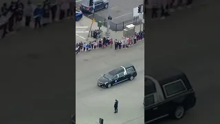 Mourners line street during procession for fallen officer