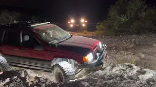 Zj on rough country long arms and 35s crawling up a 4ft ledge