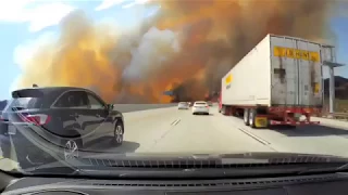 WATCH as people drive right through Los Angeles brush fires