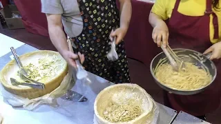 Spaghetti and Rice Hand Rolled in a Cheese Wheel. Italy Street Food