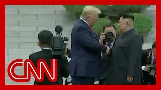 Trump and Kim Jong Un shake hands at DMZ