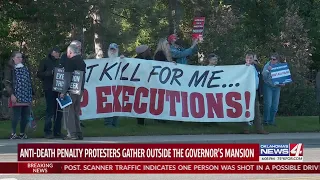 Anti-death penalty protesters gather outside the governor's mansion