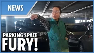 Woman STANDS in parking space to reserve a spot