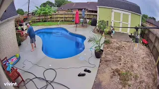 Security camera catches dad falling into the pool!