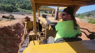 Classic Caterpillar D9G working on the steep side of a shavings pile.