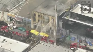 Fire crews battle raging structure fire in downtown L.A