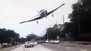 Police Dashcam Captures Small Plane Crashing Onto Florida Road