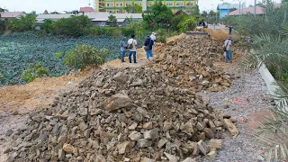 New Action Bulldozer Moving Rock To Build Road Foundation With Mighty Trucks Unloading Rock