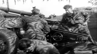 US 899th Field Artillery Battalion, 75th Division troops load 105mm howitzers and...HD Stock Footage