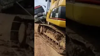 Excavator pulling truck stuck on the way #shorts