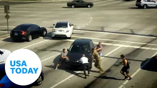 Good Samaritans in Florida save unconscious woman as car drifts through red light | USA TODAY