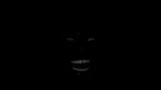 man laughing in the dark