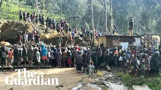 People in Papua New Guinea dig through mud and debris after huge landslide