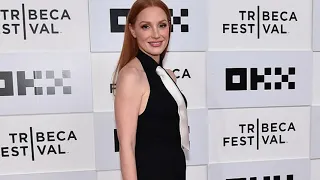 Jessica Chastain looks radiant as she slips into a black sleeveless gown with a white satin