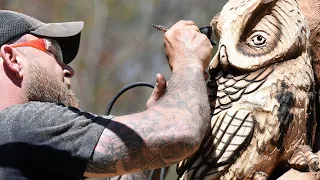 Chainsaw sculptor Josh Landry works his latest piece in Old Lyme