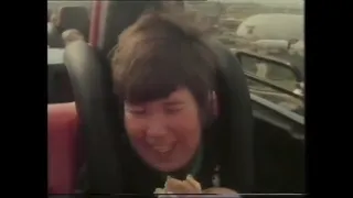 Boy scouts eating and drinking on Revolution rollercoaster 1980s