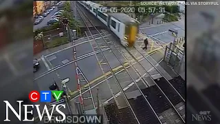 Caught on cam: Reckless pedestrian nearly hit by train