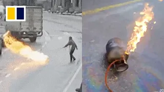 Brave police officer puts out burning gas cylinder on road