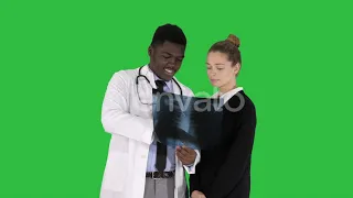 Doctor shows the patient chest x-ray on a Green Screen, Chroma Key. | Stock Footage - Videohive