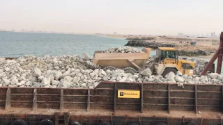 Rock barge front load ramp