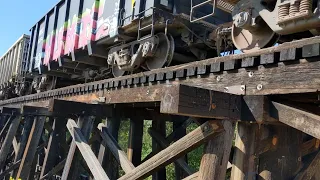 Train going over a wooden trestle bridge along the Brushy Creek Trail