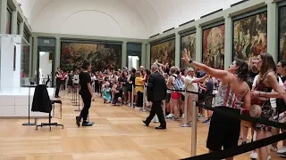 Visiting Mona Lisa at the Louvre on a busy summer day